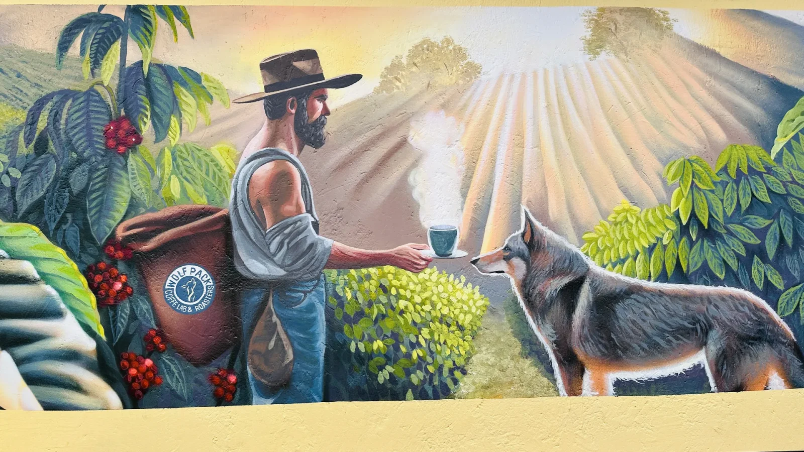 Mural del lobo y el caficultor en el laboratorio de Wolfpack